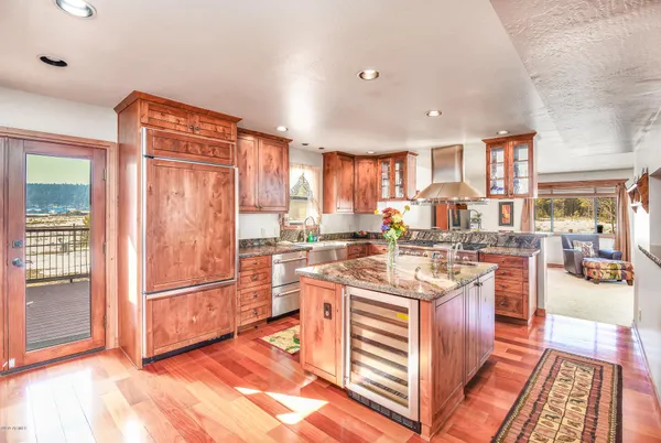 a kitchen with stainless steel appliances granite countertop a stove and a refrigerator
