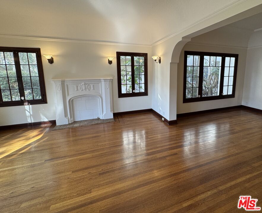 328 North Sycamore Avenue Los Angeles, CA 90036 - Photo 2 of 29 a view of an empty room with window and wooden floor