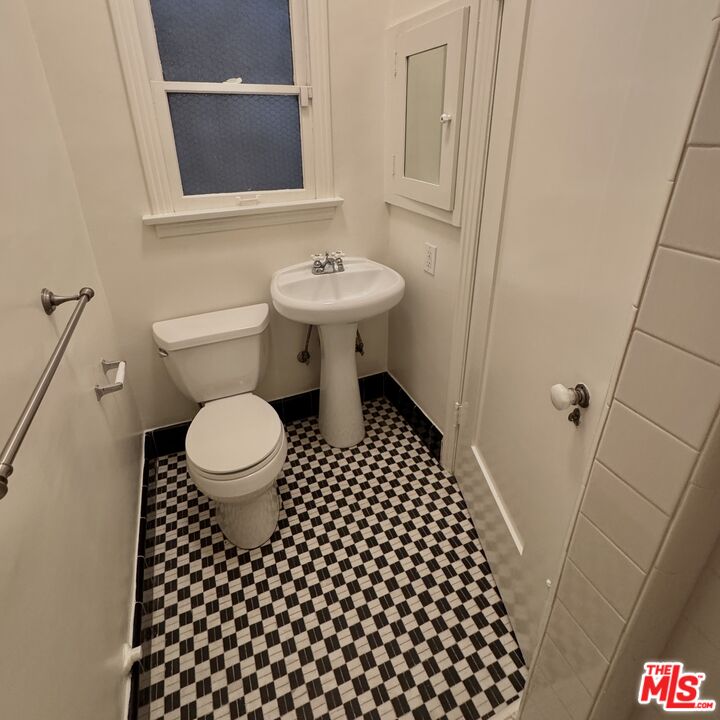 328 North Sycamore Avenue Los Angeles, CA 90036 - Photo 21 of 29 a bathroom with a toilet a sink and a mirror