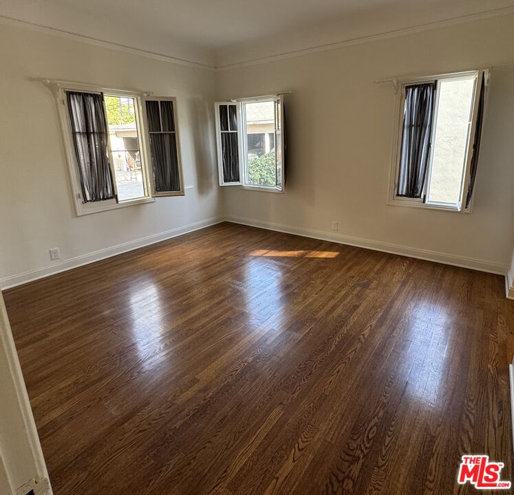 328 North Sycamore Avenue Los Angeles, CA 90036 - Photo 23 of 29 a view of an empty room with wooden floor and a window