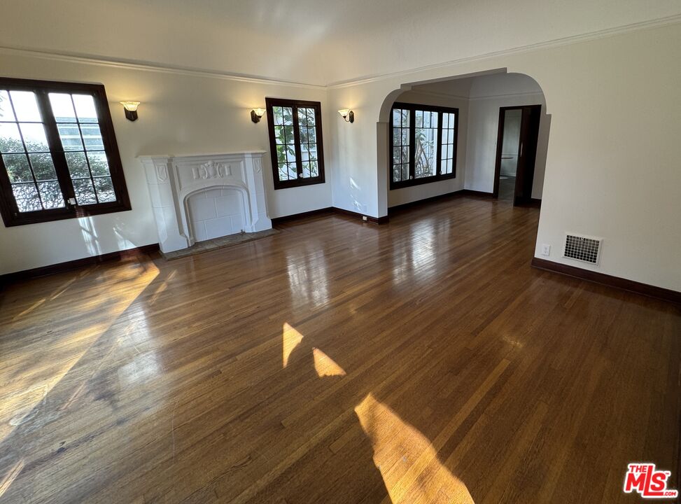328 North Sycamore Avenue Los Angeles, CA 90036 - Photo 3 of 29 a view of an empty room with window and wooden floor