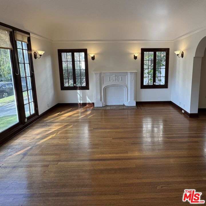 328 North Sycamore Avenue Los Angeles, CA 90036 - Photo 5 of 29 a view of an empty room with a window and fireplace
