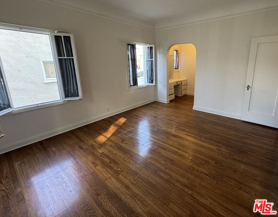 328 North Sycamore Avenue Los Angeles, CA 90036 - Photo 8 of 29 a view of empty room with wooden floor and fan
