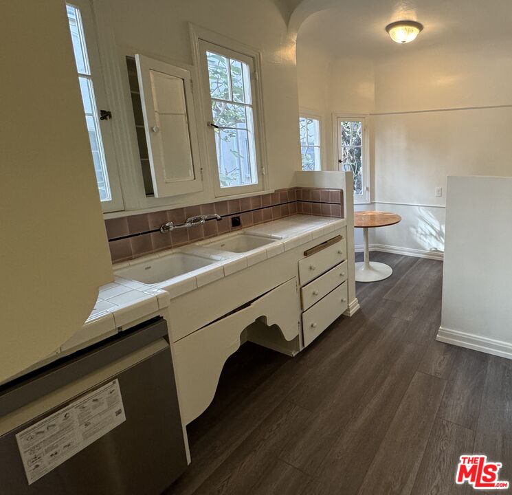 328 North Sycamore Avenue Los Angeles, CA 90036 - Photo 9 of 29 a bathroom with a double vanity sink and a mirror