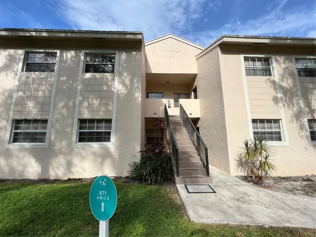 a view of a small house with backyard