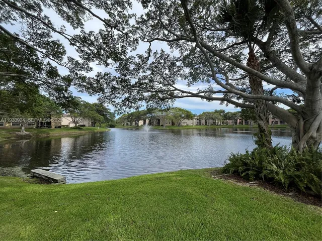 a view of a lake with houses in the background