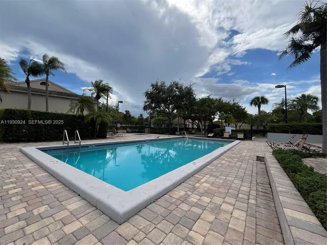 a view of swimming pool with seating space