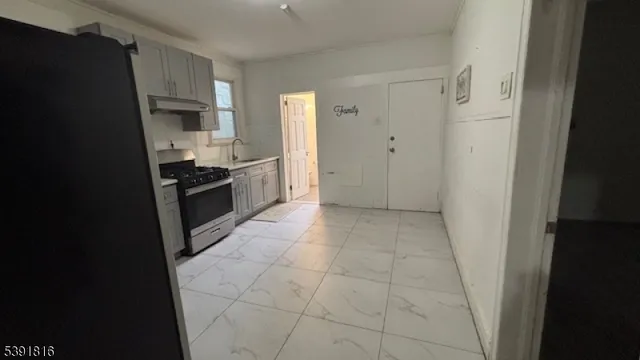 a kitchen with stainless steel appliances granite countertop a refrigerator sink and stove