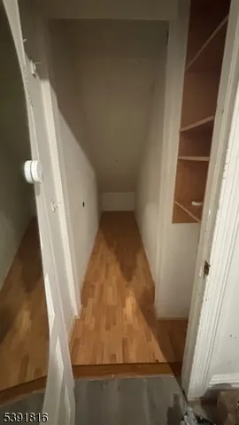 a view of a room with wooden floor