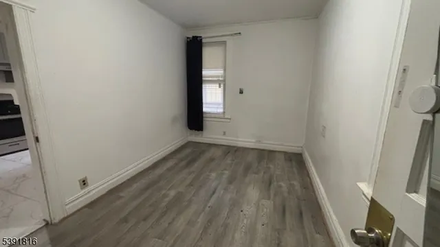 a kitchen with granite countertop a refrigerator and a stove top oven