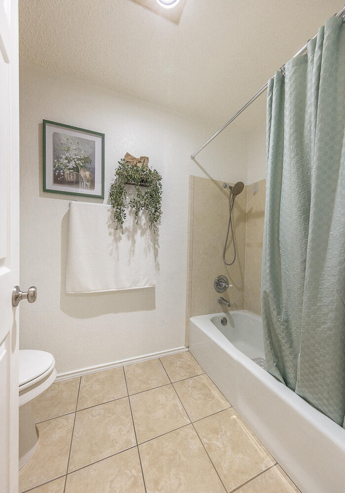 5810 80th Street Lubbock, TX 79424 - Photo 14 of 29 a bathroom with a bathtub and a shower