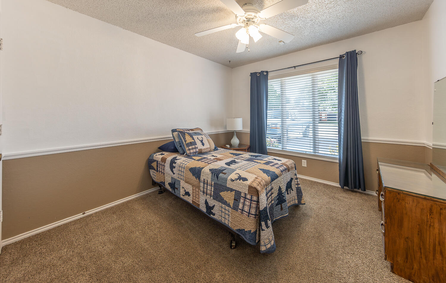5810 80th Street Lubbock, TX 79424 - Photo 15 of 29 a bedroom with a bed and a chandelier