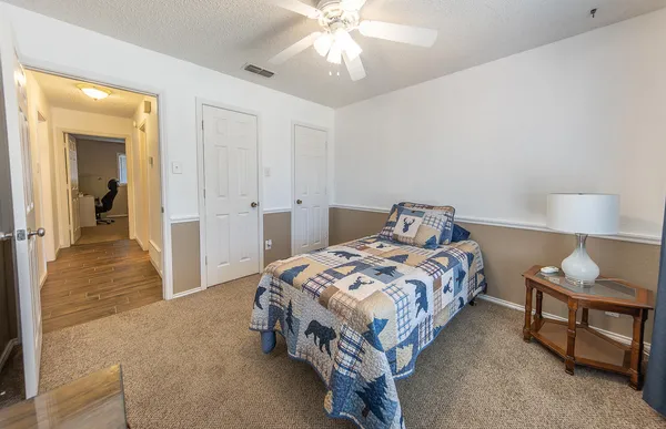 a bedroom with a bed and a chandelier