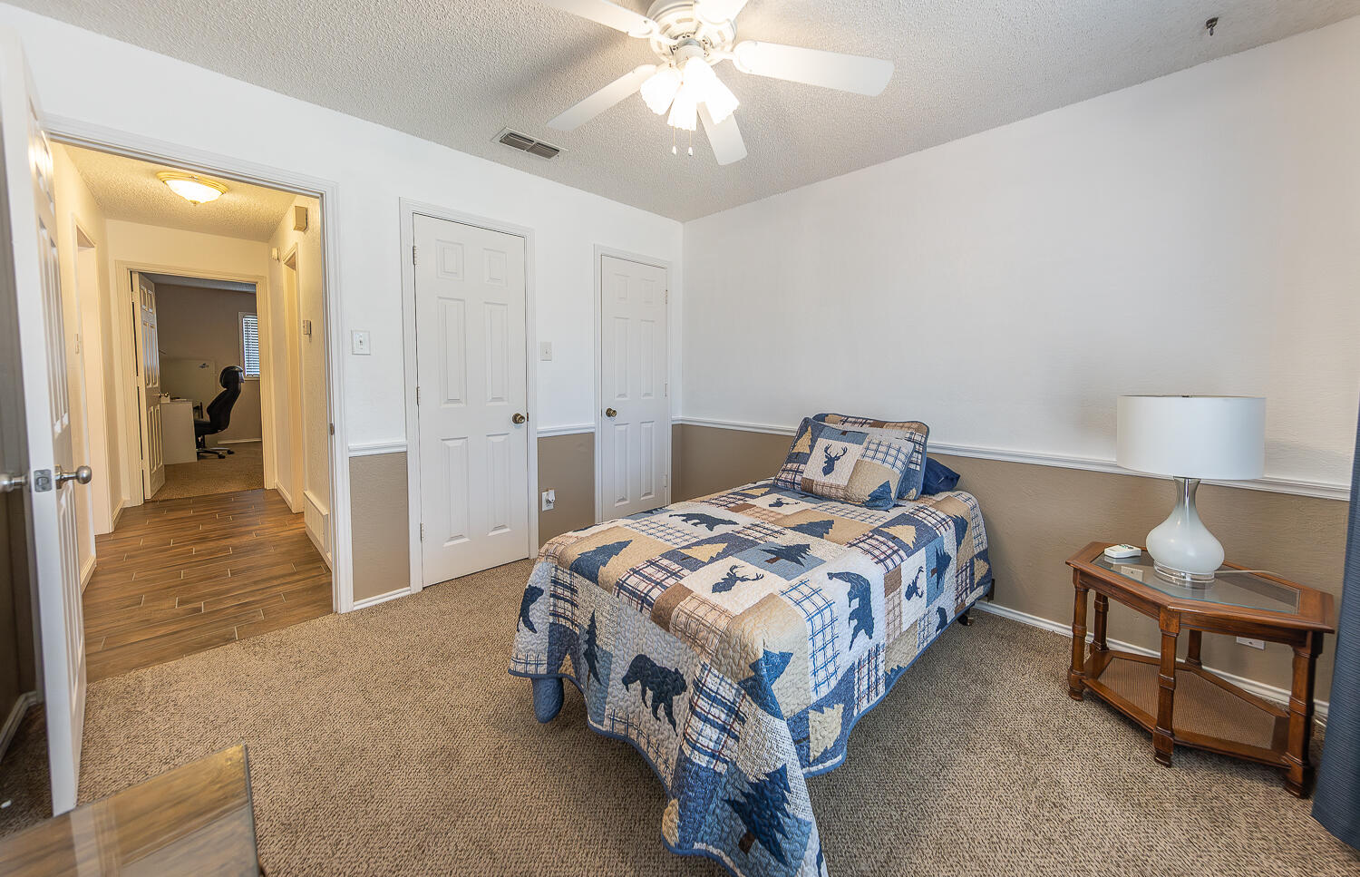 5810 80th Street Lubbock, TX 79424 - Photo 16 of 29 a bedroom with a bed and a chandelier