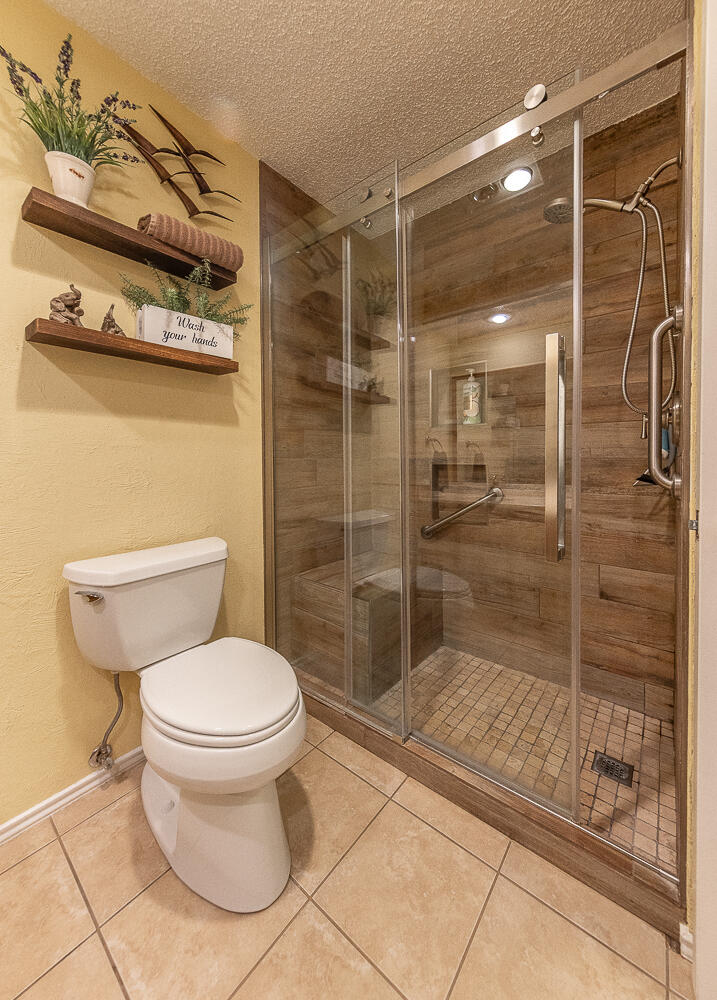 5810 80th Street Lubbock, TX 79424 - Photo 18 of 29 a bathroom with a shower and a toilet