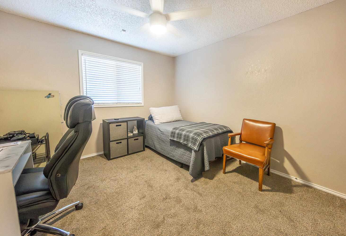 5810 80th Street Lubbock, TX 79424 - Photo 19 of 29 a bedroom with a bed chair and window