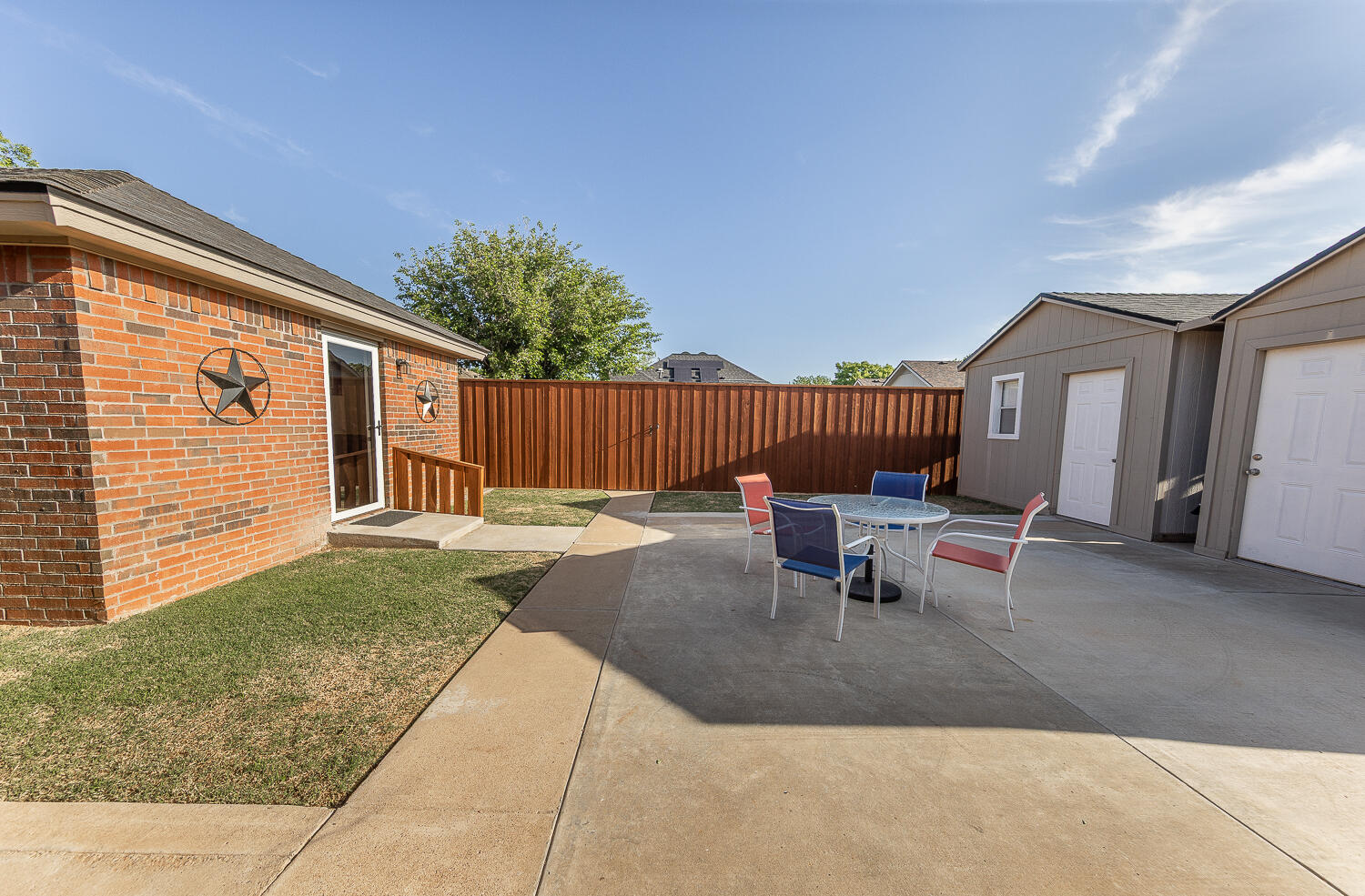 5810 80th Street Lubbock, TX 79424 - Photo 22 of 29 a view of a patio with a table and chairs