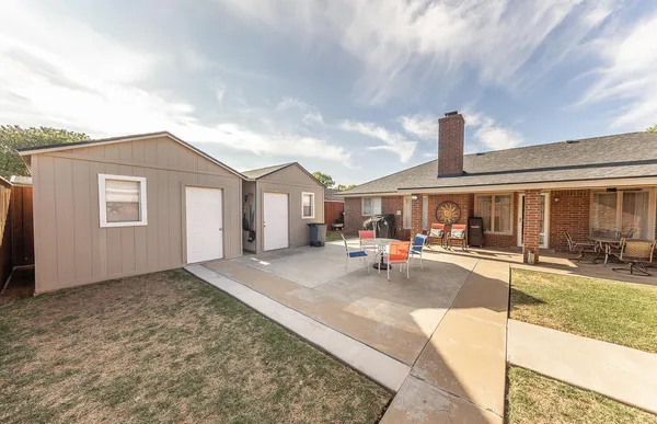 a view of a house with outdoor space and sitting area