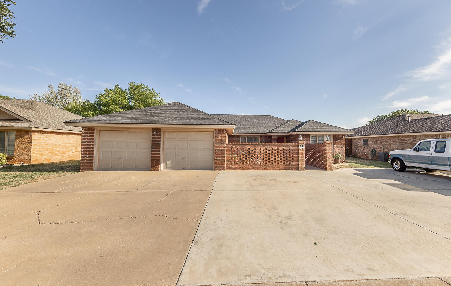5810 80th Street Lubbock, TX 79424 - Photo 29 of 29 a front view of a house with a yard and garage
