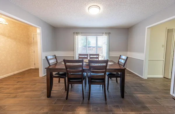 a view of a dining room with furniture and a window