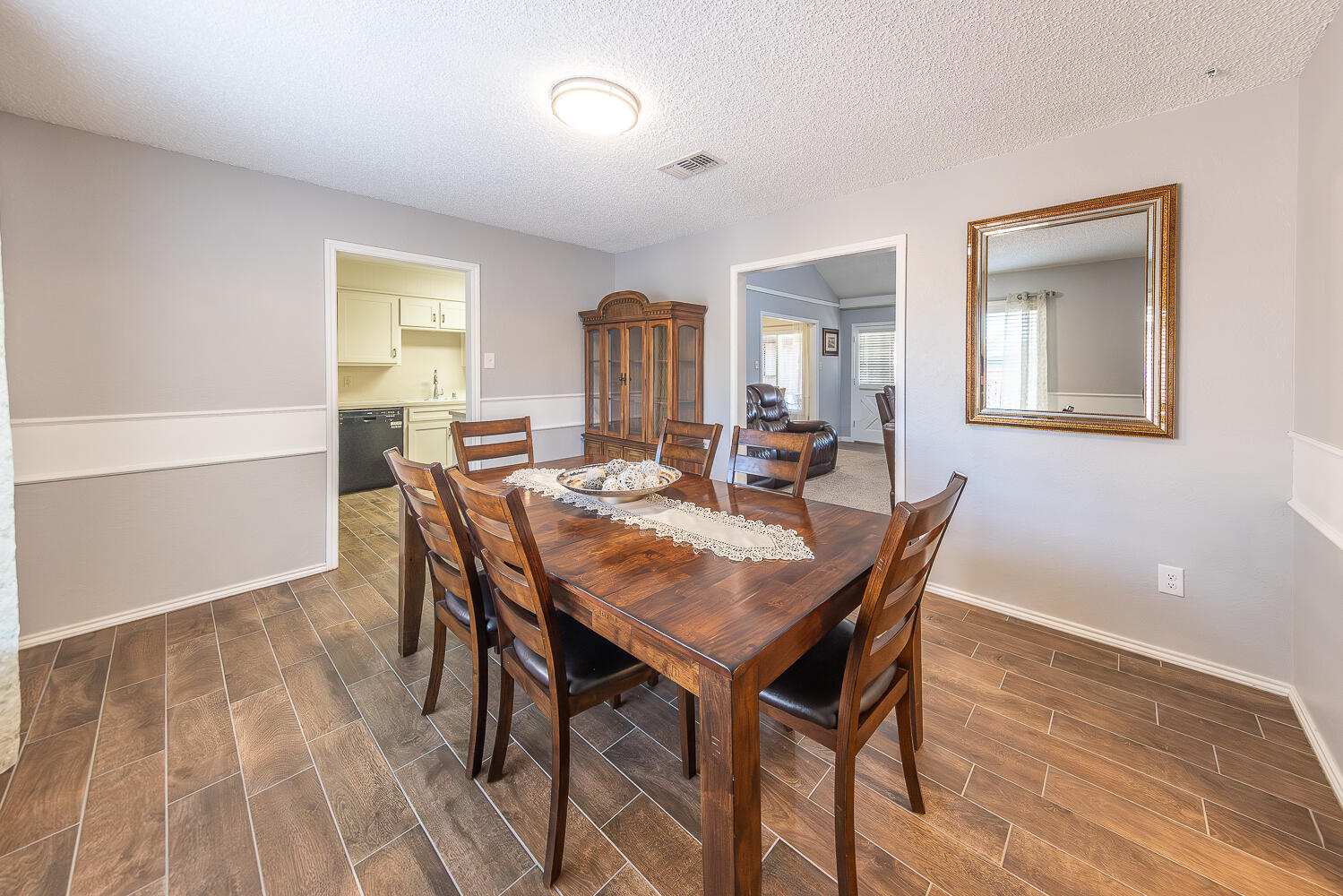 5810 80th Street Lubbock, TX 79424 - Photo 7 of 29 a view of a dining room with furniture and wooden floor