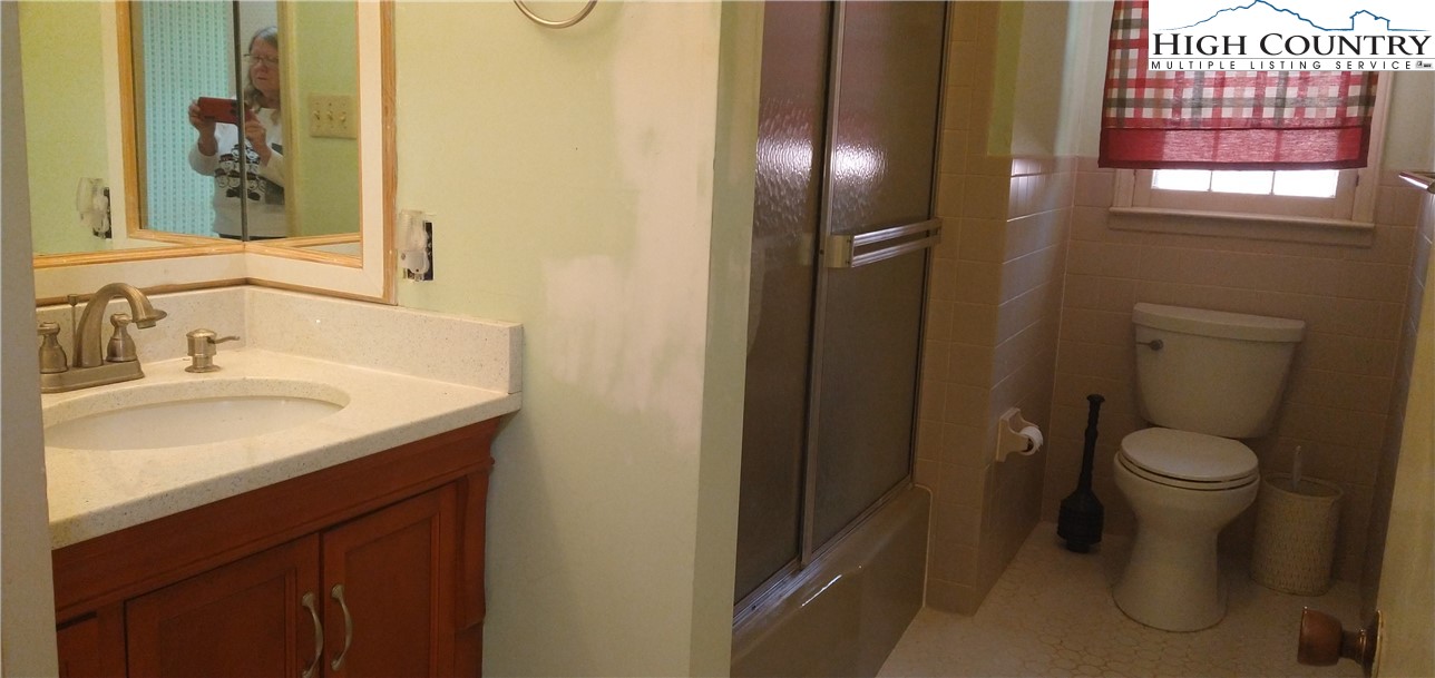 308 Hickory Mountain Road Sparta, NC 28675 - Photo 13 of 26 a bathroom with a sink toilet and shower