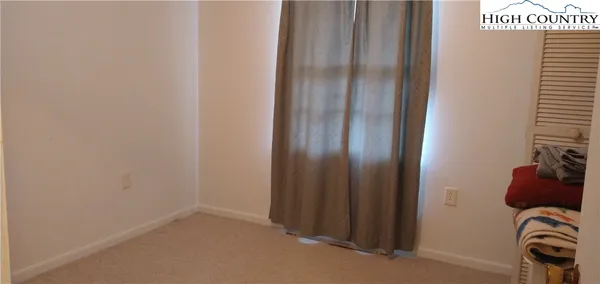 a bed sitting in a bedroom next to a lamp