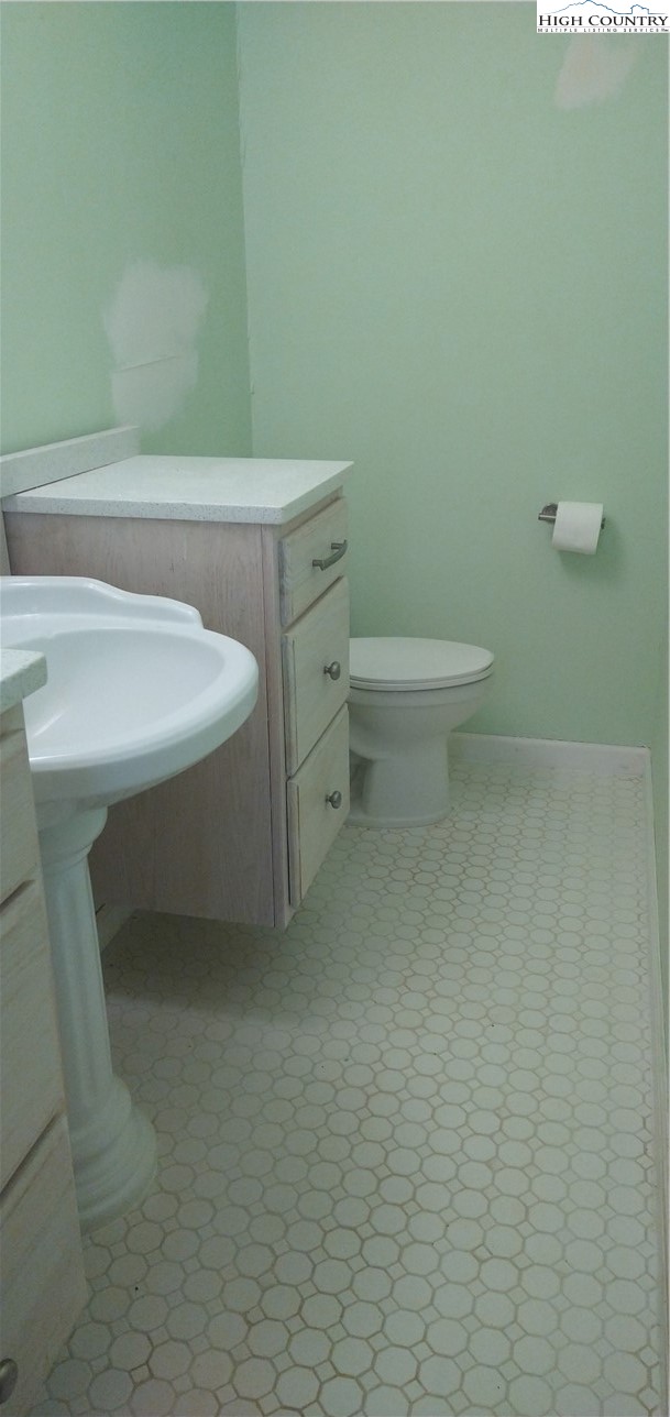 308 Hickory Mountain Road Sparta, NC 28675 - Photo 19 of 26 a bathroom with a sink and a toilet
