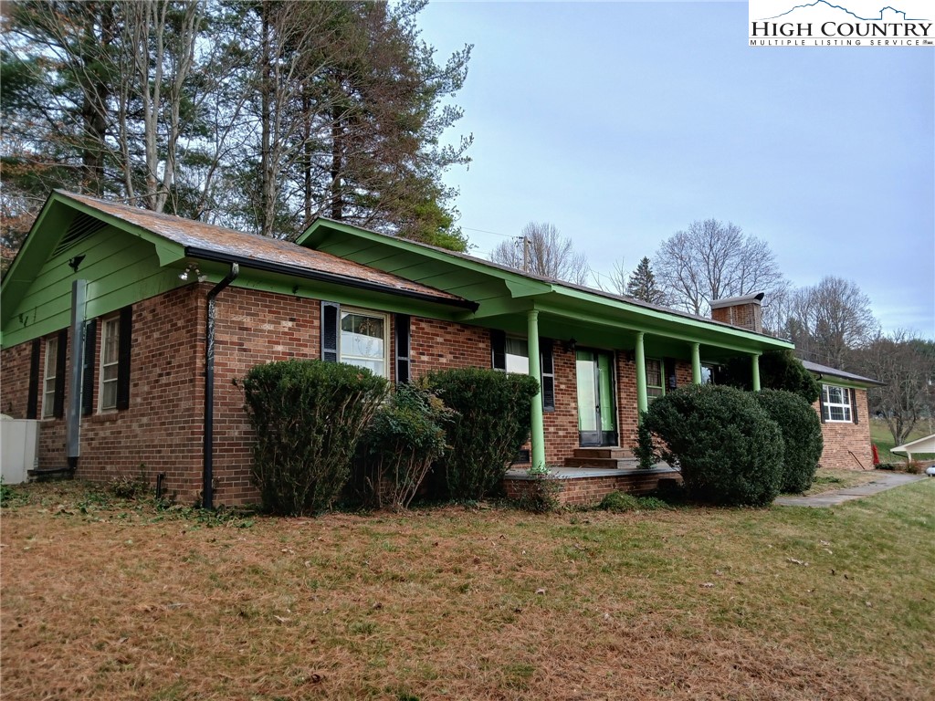 308 Hickory Mountain Road Sparta, NC 28675 - Photo 2 of 26 a front view of a house with garden