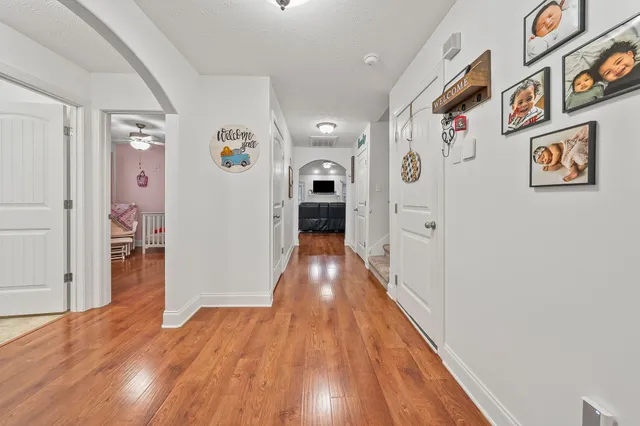 a view of a hallway view with wooden floor and staircase