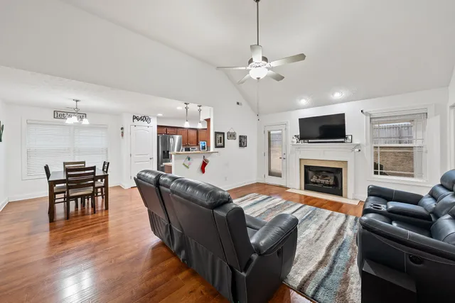 a living room with furniture a fireplace and a flat screen tv