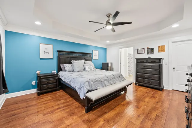 a bedroom with a bed and a chandelier