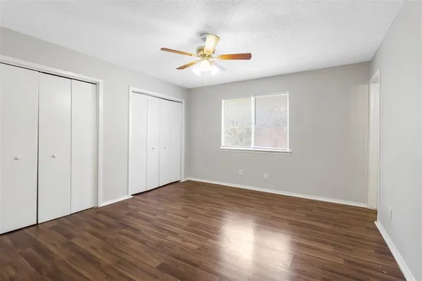 a kitchen with white cabinets and appliances