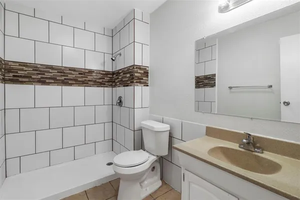 an empty room with closet and a chandelier fan