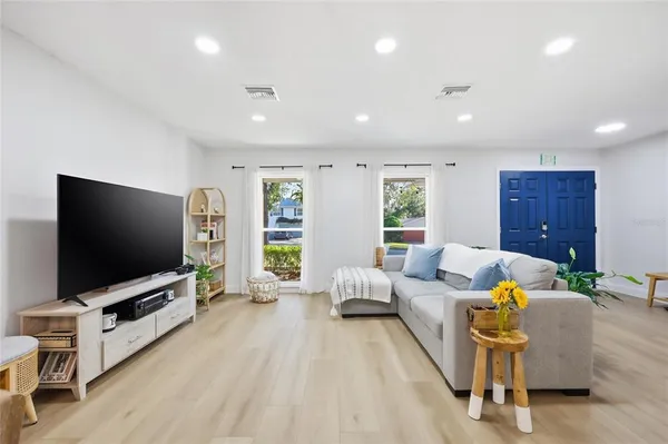 a living room with furniture and a flat screen tv