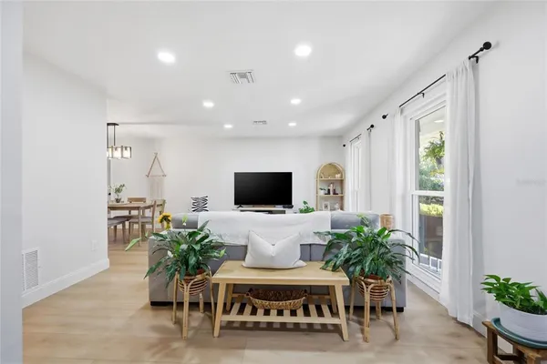 a view of a dining room with furniture and wooden floor