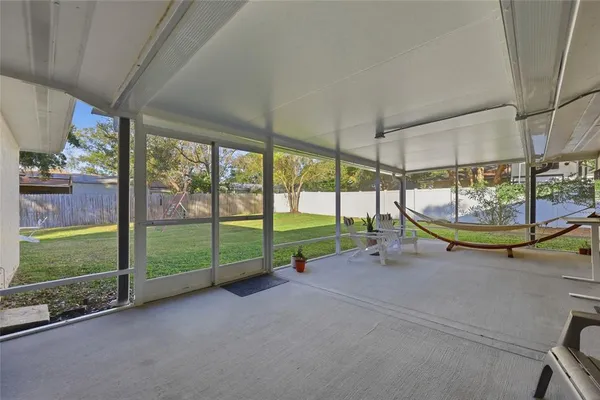 a view of a house with backyard sitting area and garden