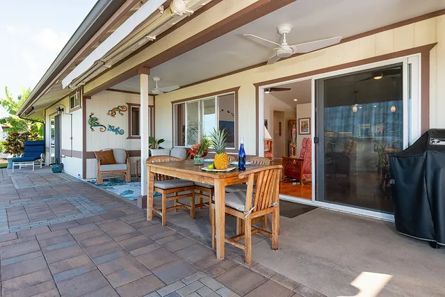 a view of a dining room with furniture and a chandelier