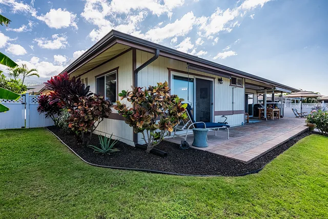 a front view of house with a garden