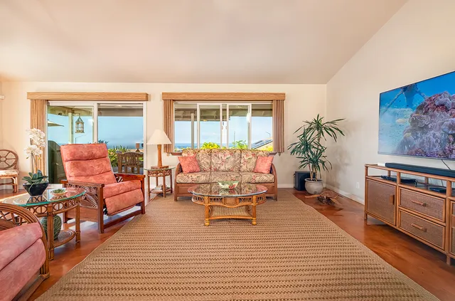a living room with furniture and a potted plant