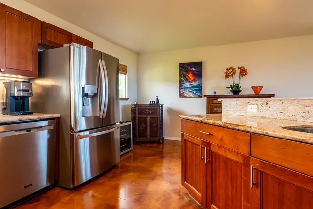 a kitchen with stainless steel appliances a refrigerator and a stove