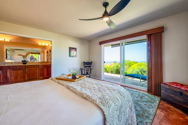 a bedroom with a bed and large windows