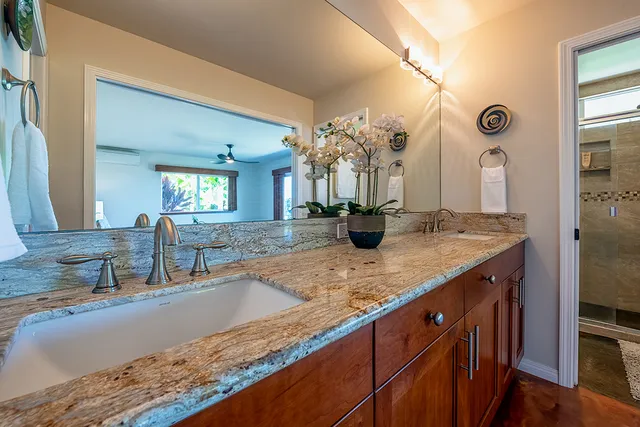 a view of living room and kitchen with granite countertop a sink