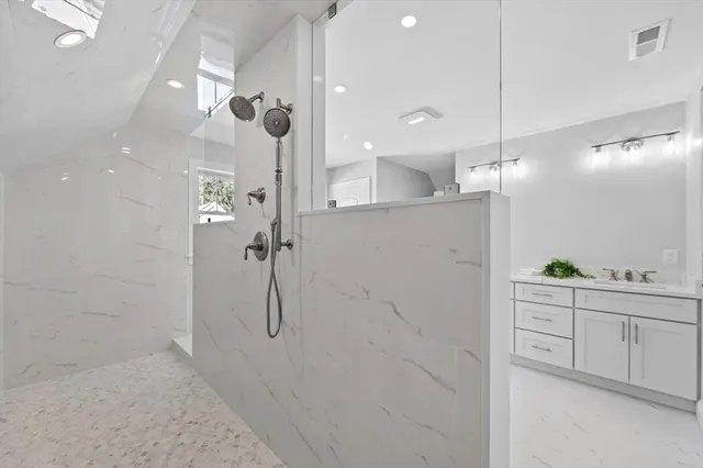 a bathroom with a shower and a sink