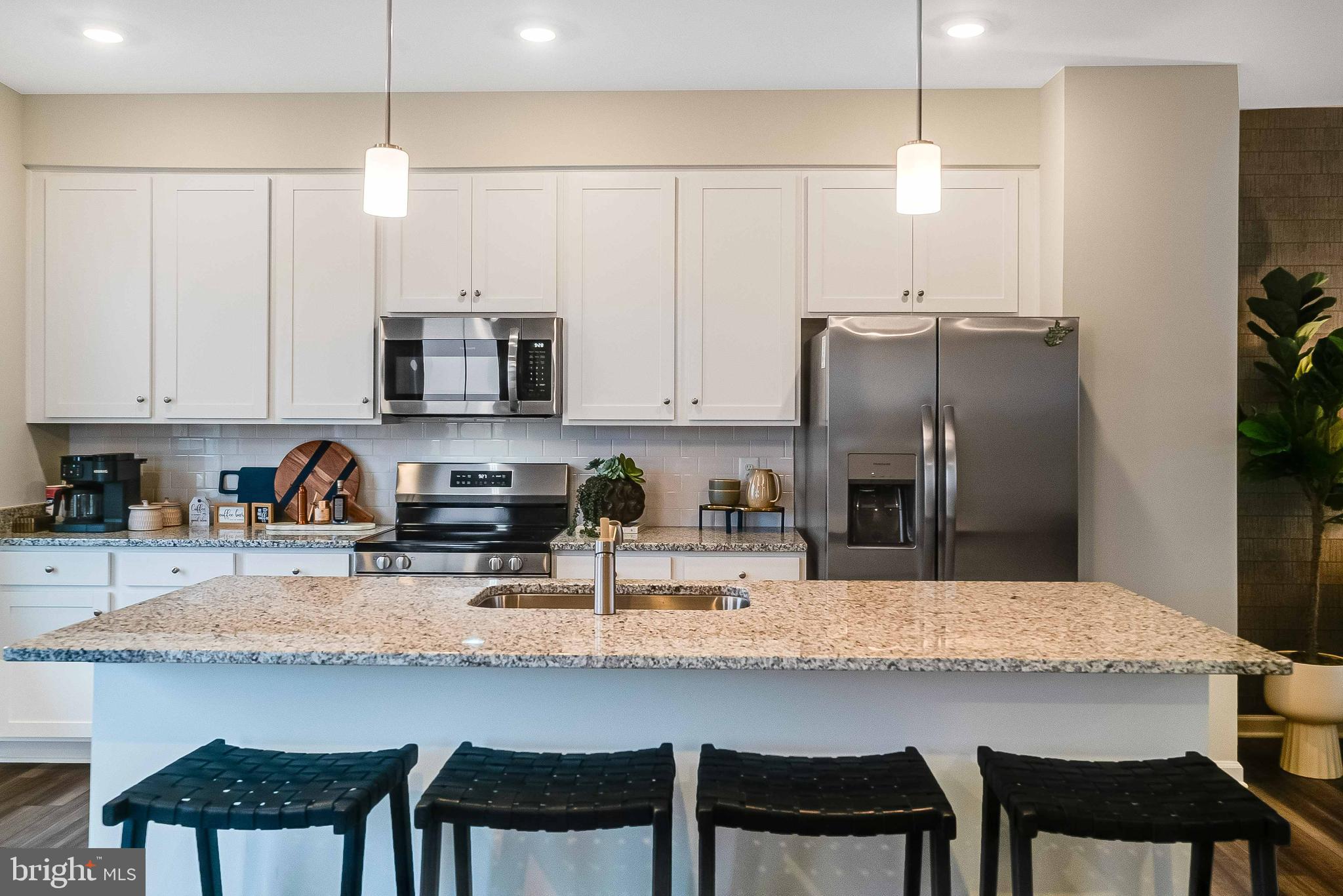 1260 Red Clover Lane Ranson, WV 25438 - Photo 9 of 24 a kitchen with stainless steel appliances a table chairs refrigerator and microwave