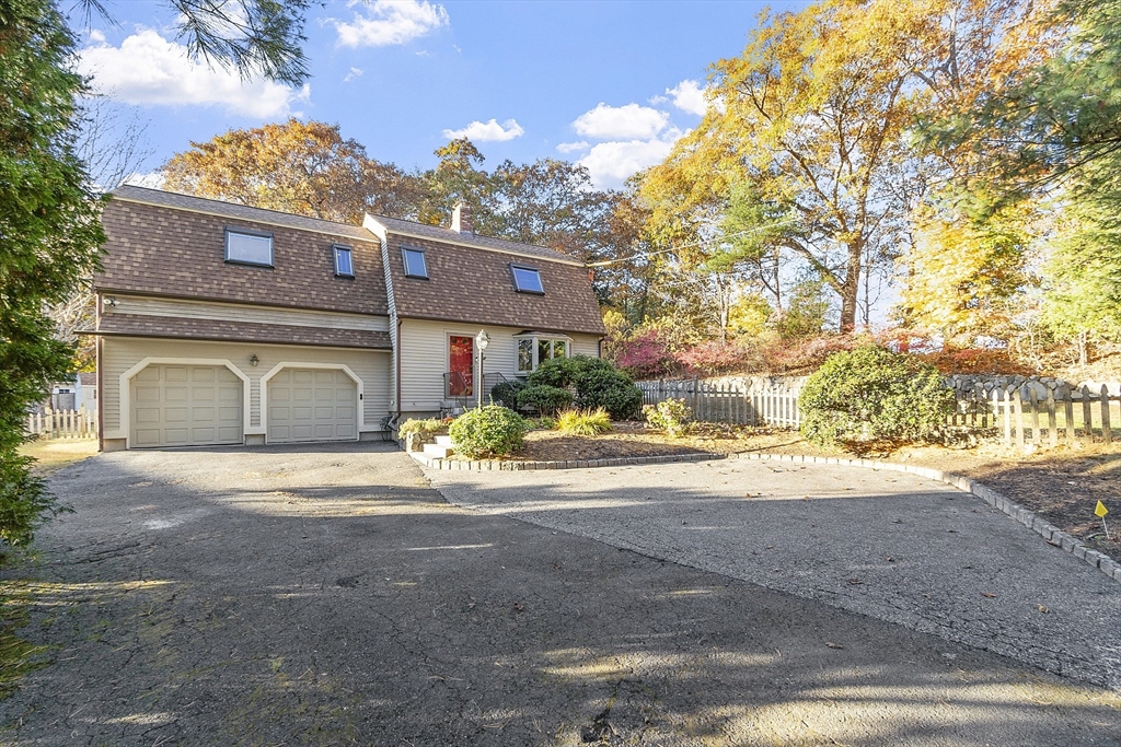 51 Kenney Road Middleton, MA 01949 - Photo 2 of 33 a front view of a house with a yard and garage