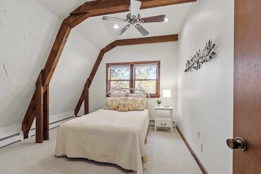 51 Kenney Road Middleton, MA 01949 - Photo 21 of 33 a bedroom with a large bed and a chandelier