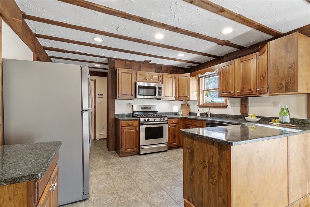 51 Kenney Road Middleton, MA 01949 - Photo 7 of 33 a kitchen with stainless steel appliances granite countertop a stove sink and refrigerator