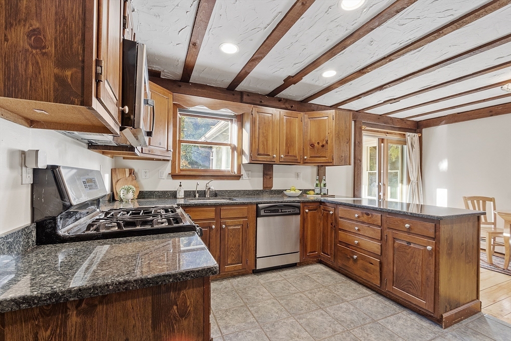 51 Kenney Road Middleton, MA 01949 - Photo 9 of 33 a kitchen with stainless steel appliances granite countertop sink stove and cabinets