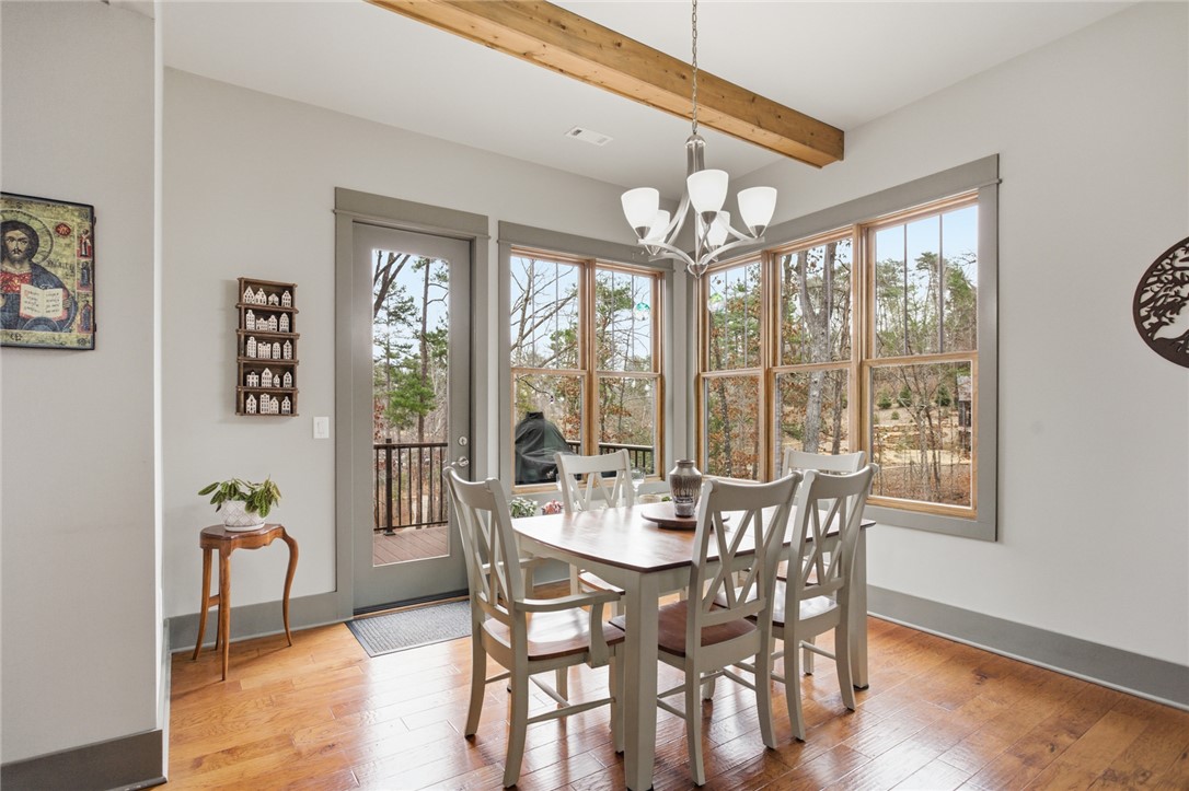 412 Walking Fern Way Seneca, SC 29672 - Photo 12 of 45 This bright dining area features expansive windows, rich hardwood flooring, and direct access to an outdoor grill deck.